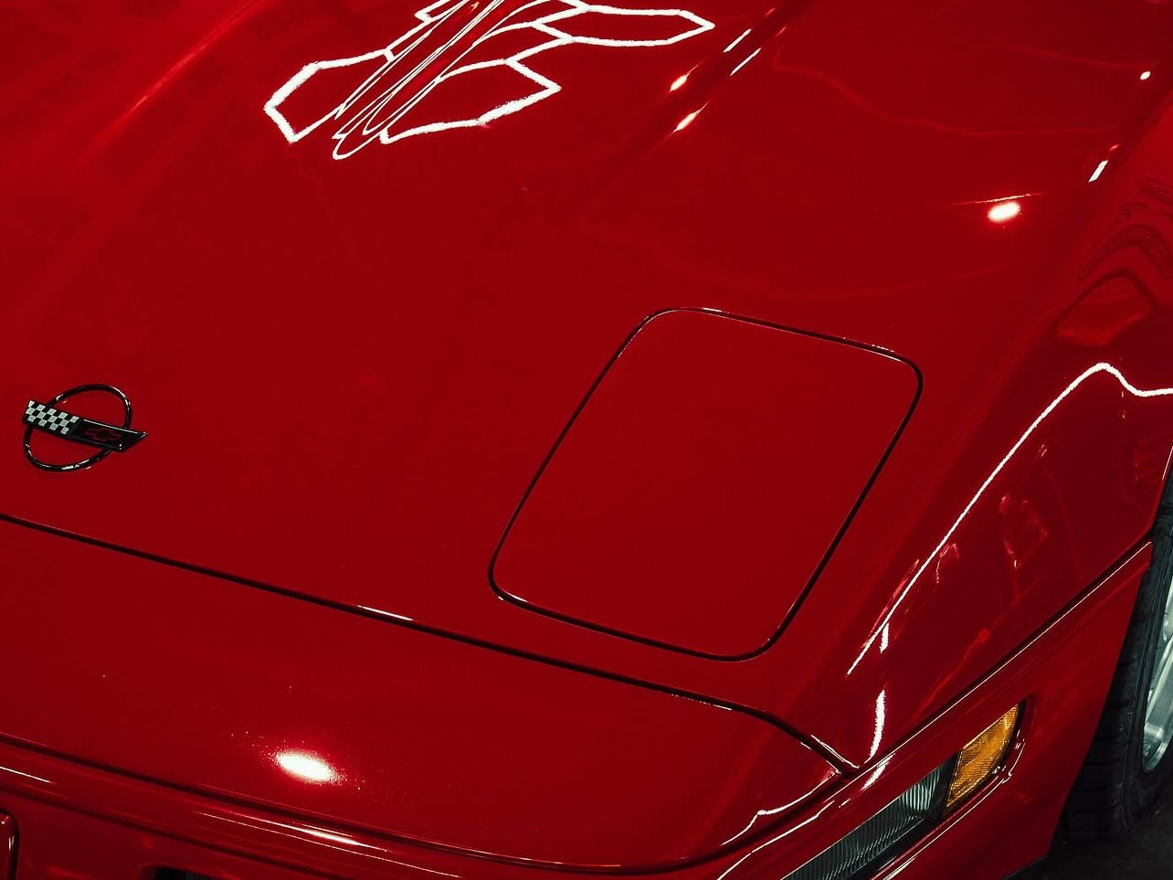 Corrected red clear coat throwing a clean reflection of the shop lighting at Slick Auto Care Little Rock AR