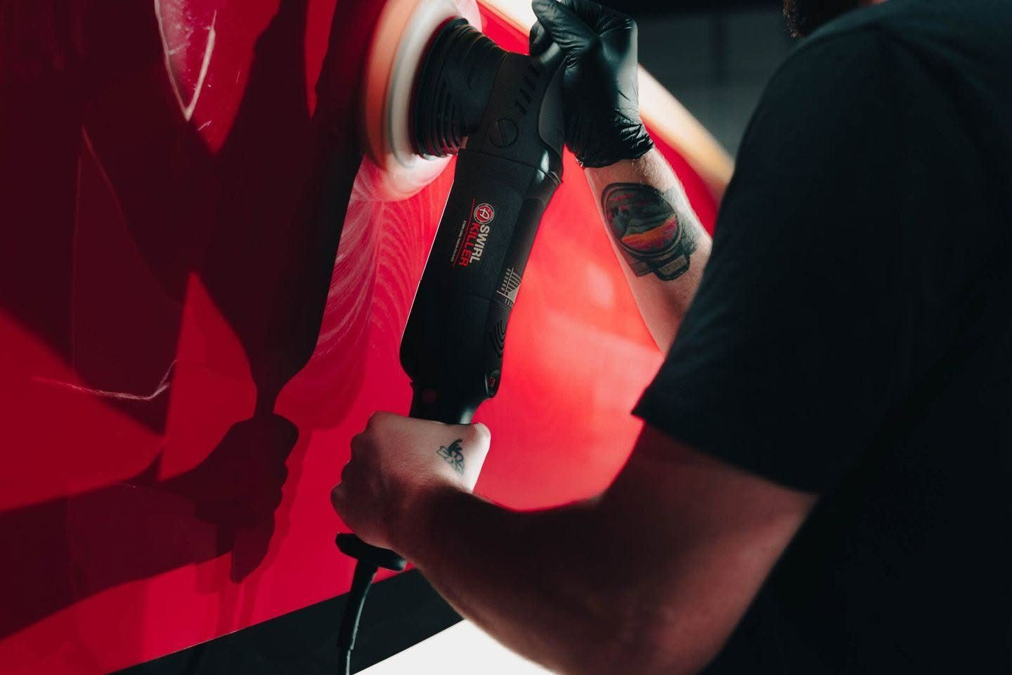 Dual action polisher removing swirl marks from red paint at Slick Auto Care in Little Rock AR